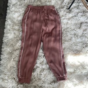 Zara size small pink silky joggers with white trim.